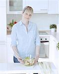 Young woman making salad