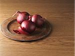 Red Onions on Metal Plate on Wooden Background, Studio Shot