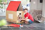 Boy building kennel for his dog