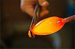 Person cutting glass with hand tool