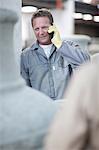 Factory worker talking on cellular phone