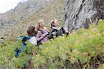 Young hikers looking up at rock