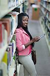 Female student using digital tablet in library