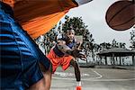 Young basketball players playing on court, close up