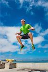 Young man jumping while fitness training