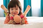 Girl playing with dolly in bedroom