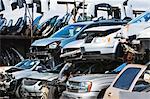 Cars stacked in scrap yard