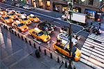 Yellow cabs and cars at  pedestrian crossing New York City, USA