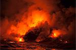 Smoke clouds from lava flow impacting sea at night, Kilauea volcano, Hawaii