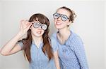Two girls wearing fake glasses