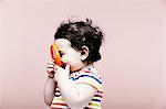 Portrait of baby girl holding plastic toy