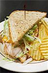 Turkey sandwich with cheese and salad and crisps