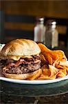 Peanut Butter Bacon Burger with Sweet Potato Chips on a White Plate