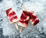 Ice lollies (raspberry and vanilla) on ice cubes