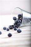 Lots of blueberries in an overturned glass