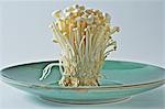 Fresh enoki mushrooms on a plate