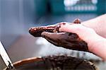 Truffles being rolled in melted chocolate