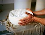 Hands Working with Urner Alpkäse (Swiss) Cheese