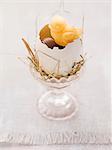 An Easter nest in an eggcup with sweets