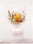 An Easter nest in an egg cup with sweets