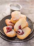 Madeleines with raspberries and icing sugar