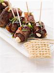 Date skewers with dry-cured ham and almonds
