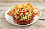 Guacamole with pomegranate seeds and tortilla chips