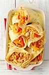 Pancakes filled with chicken, peppers and pineapple, in garlic sauce