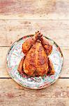 A whole roast chicken on a ceramic dish