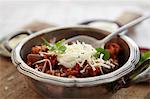 Chicken chilli with sour cream and grated cheese