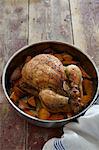 A whole roast chicken with yams