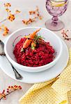 Roasted Beet Risotto with Glazed Carrots and Fresh Dill in a White Bowl