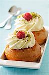 Rum baba with whipped cream and raspberries