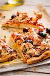 Sliced Barbecue Chicken and Olive Pizza on Parchment Paper
