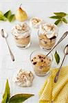 Pear Dessert Topped with Meringues in Glasses with Spoons