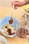 Biscuit dough being prepared: ingredients in a bowl (oil, butter, wholemeal flour, eggs, brown sugar)