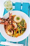 Halved Lobster with Couscous and Vegetables; In a White Bowl
