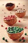 Colourful peppercorns in walnut shells