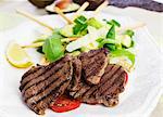 Barbecued beef steaks with avocado salad