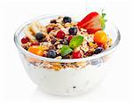 Fruit muesli with yoghurt in a glass bowl
