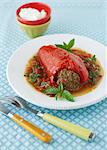 Stuffed Red Bell Pepper in Tomato Basil Sauce on a White Plate