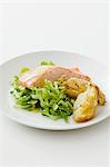 Poached salmon fillet with mustard sauce on a bed of salad
