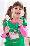 A girl holding two egg-shaped cake pops