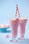 Strawberry milkshake with marshmallows in two glasses