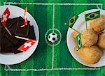 Chocolate (Switzerland) and salgadinhos (Brazil) with football-themed decoration