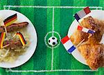 Sausages with cabbage (Germany) and croissants (France) with football-themed decoration