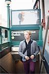 Young man emerging from subway station Brooklyn, New York City, USA