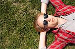 Young man lying down in park