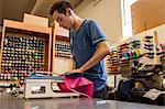 Worker using embroidery machine in t-shirt  printing workshop