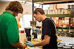 Workers checking inks in screen printing workshop